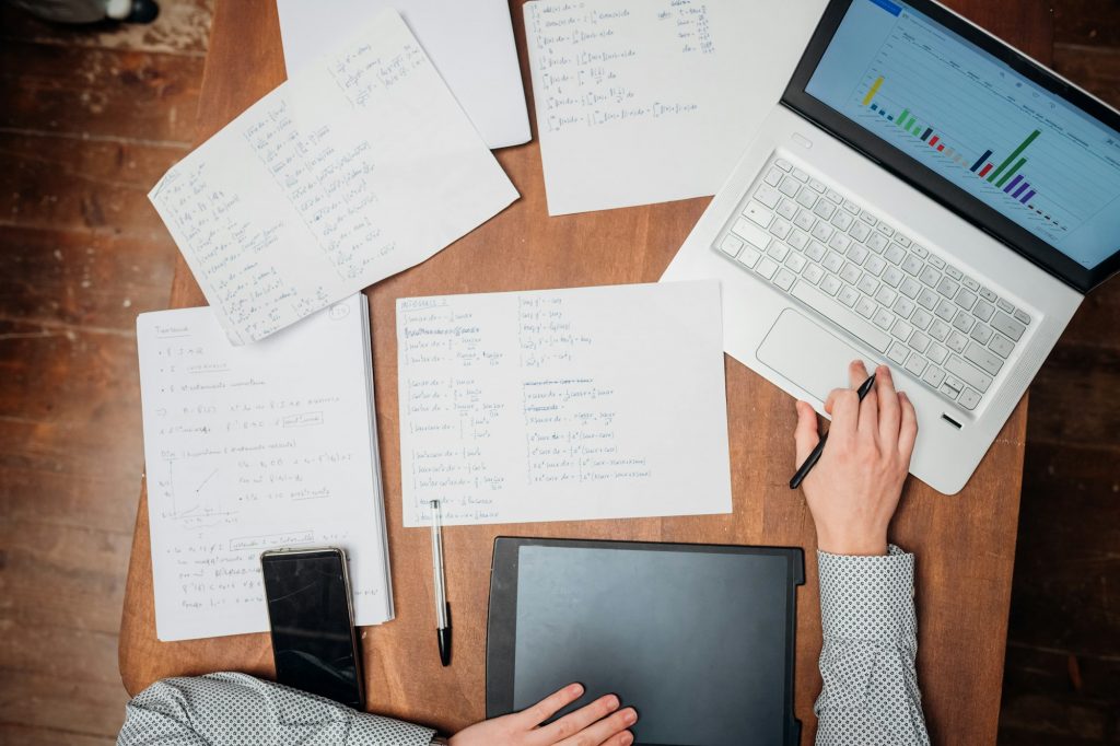 High angle view working place in office - man using digital tablet and smartphone